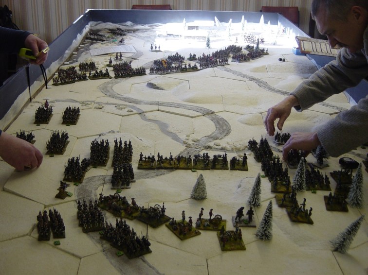 The French deployed on the ridge east of the village with their cavalry sheltered rear/left. Off-table on the west bank, twelve 12 pounders from Napoleon’s Reserve were poised to enfilade any Russian units that hugged the river bank too closely. On the Russian side, MG Vlastov prepared to engage on the left, while GM Berg crossed the stream. In the Russian centre, deployed on the slope overlooking the ford, is the 12 pdr battery that began firing at long range. Vlastov decided to move it closer to effective range but that was an error; the limbered guns proved to be a hindrance and would have been better left alone.