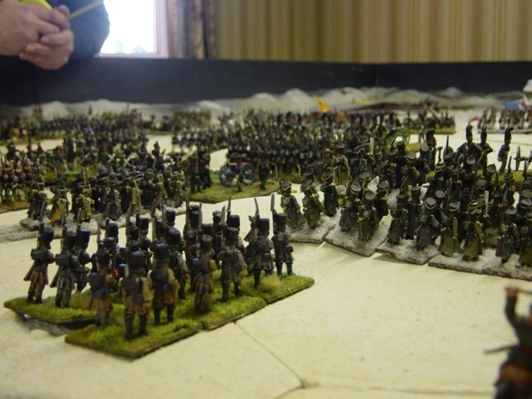 Kulniev’s Brigade attacks. In the foreground, the St Petersburg Militia march behind the Navajinski Infanty regiment. The brigade artillery pounds at the French right. When the order changes from ENGAGE to ASSAULT, two battalions of Jagers attack in massed columns on the extreme right of the French line. The attack looks promising but it falls into disorder, because the columns are too close to each other. They cannot get to grips with the enemy. The assault grinds to a halt.